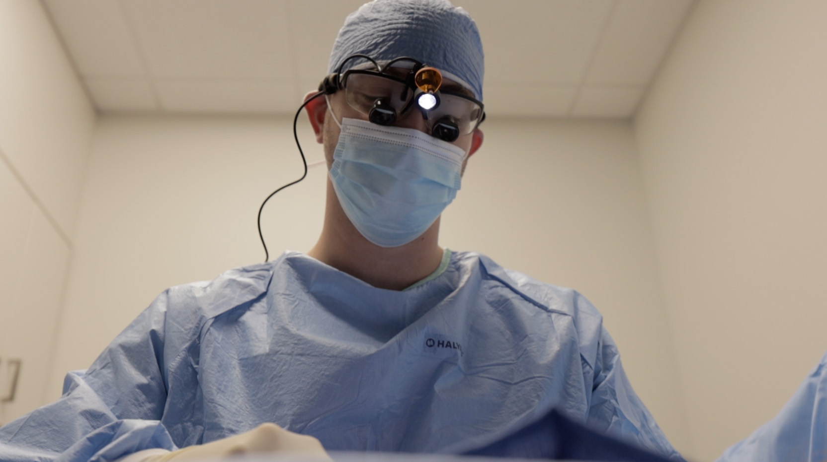 Orthopaedic surgeon in sterile gown and mask