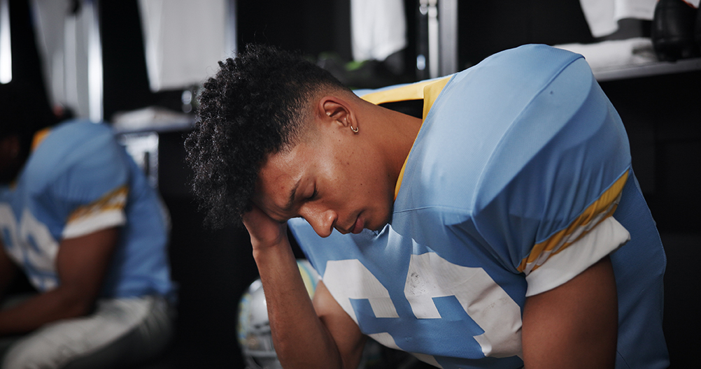 football player holding head